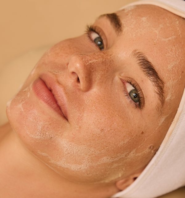 Client in a white headband after a microneedling treatment